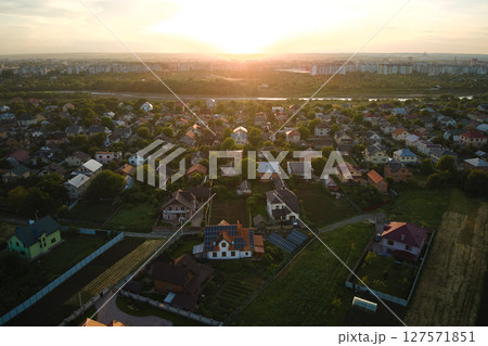 Aerial view of residential houses in suburban rural area at sunset Aerial view of residential houses in suburban rural area at sunset 127571851