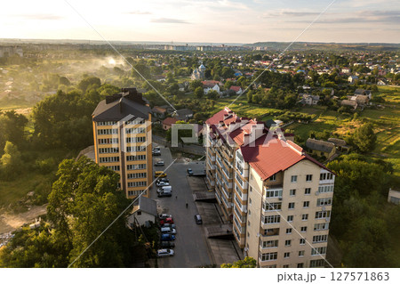 Aerial view of multistory apartment buildings in green residential area. Aerial view of multistory apartment buildings in green residential area. 127571863