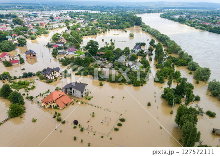 Aerial view of flooded houses with dirty water of Dnister river in Halych town, western Ukraine. 127572111