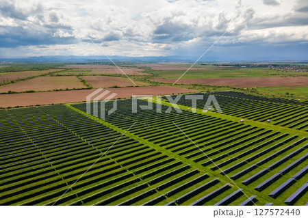 Aerial view of big sustainable electric power plant with many rows of solar photovoltaic panels for producing clean ecological electrical energy. Renewable electricity with zero emission concept. 127572440