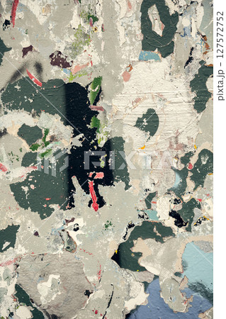Textured wall with peeling paint in abstract pattern of muted greens, whites, and pops of red Textured wall with peeling paint in abstract pattern of muted greens, whites, and pops of red 127572752