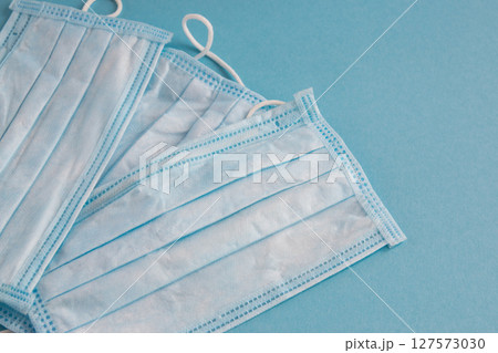 Medical mask for face on the blue background. Antibacterial, against pollution or virus protection. Health care. Medical mask for face on the blue background. Antibacterial, against pollution or virus protection. Health care. 127573030