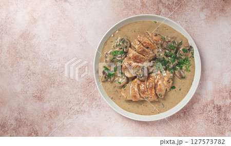 chicken in cream sauce with mushrooms, on a plate, no people 127573782