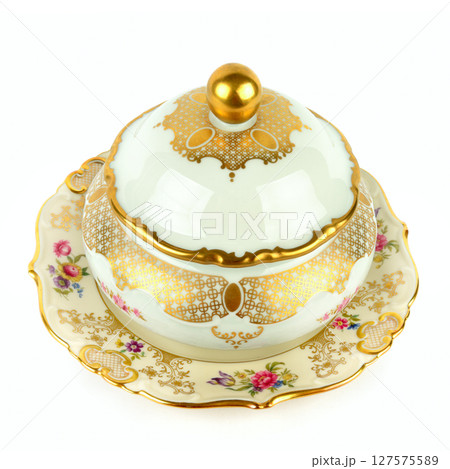 Porcelain vintage sugar bowl and a vintage porcelain plate isolated on white. 127575589