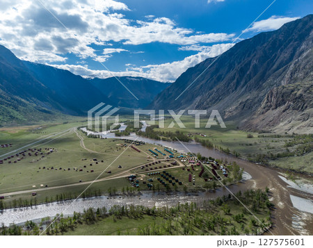 Summer landscape in the Chulyshman mountain valley. Winding mountain river, green alpine meadows and beautiful mountains. Summer landscape in the Chulyshman mountain valley. Winding mountain river, green alpine meadows and beautiful mountains. 127575601