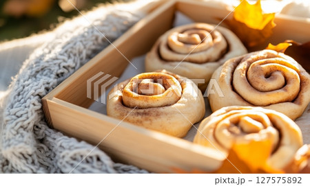 Warm for golden cinnamon rolls on wooden tray 127575892