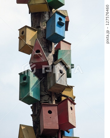 Lots of colorful wooden birdhouses 127576460