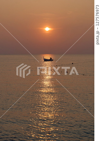 the atmosphere of the fishermen in the evening after returning home from fishing in the sea using a wooden boat the atmosphere of the fishermen in the evening after returning home from fishing in the sea using a wooden boat 127576973