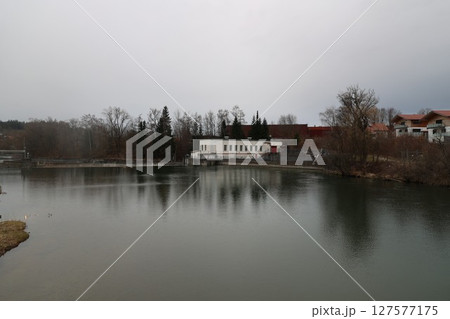 A calm lake with a house in the background A calm lake with a house in the background 127577175