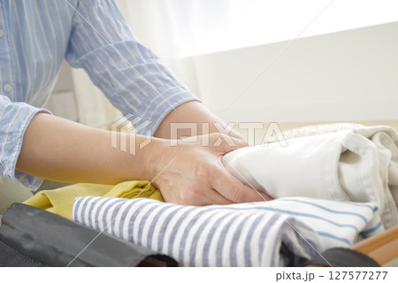 旅行の支度をする女性のパッキング風景 127577277