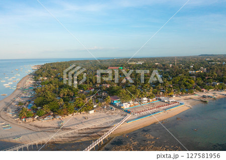 Aerial view of baywalk and fishing boats over the sea in Bantayan Island. Kota Park and sandy beaches in Cebu, Philippines. Aerial view of baywalk and fishing boats over the sea in Bantayan Island. Kota Park and sandy beaches in Cebu, Philippines. 127581956