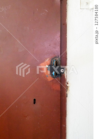 brown iron barn door with black padlock 127584180