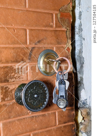 entrance door to the apartment with a lock and keys 127584185