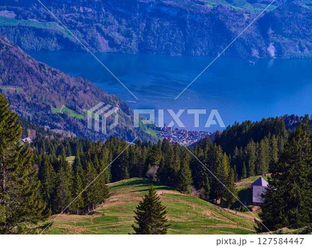 Natural beauty of a serene lake nestled between mountains in a tranquil landscape 127584447