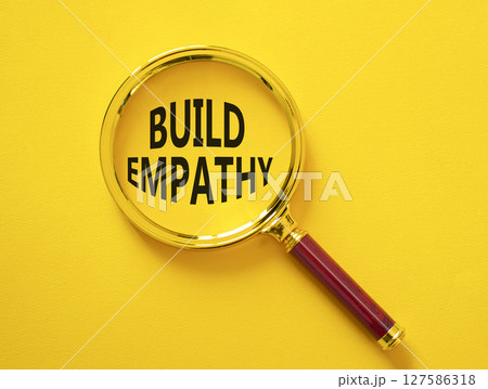 Build empathy symbol. Magnifying glass with words Build empathy. Beautiful yellow background. Business and Build empathy concept. Copy space. Build empathy symbol. Magnifying glass with words Build empathy. Beautiful yellow background. Business and Build empathy concept. Copy space. 127586318