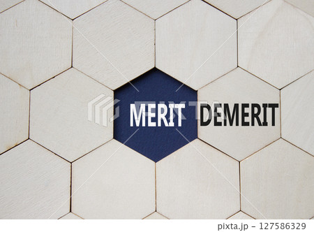 Merit or Demerit symbol. Concept word Merit or Demerit on wooden comb puzzle. Beautiful deep blue background. Business and Merit or Demerit concept. Copy space Merit or Demerit symbol. Concept word Merit or Demerit on wooden comb puzzle. Beautiful deep blue background. Business and Merit or Demerit concept. Copy space 127586329