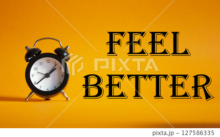 Feel better symbol. Beautiful orange background with alarm clock. Business and Feel better concept. Copy space. Feel better symbol. Beautiful orange background with alarm clock. Business and Feel better concept. Copy space. 127586335