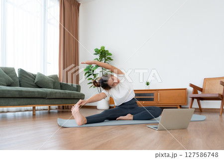 Young Asian woman stretching yoga workout on exercise mat Young Asian woman stretching yoga workout on exercise mat 127586748