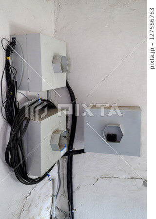 electrical equipment on the wall of a building, installation of electrical equipment in a building 127586783