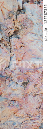 Large vertical shot of rough background of rock texture in pinkish tones. 127587386
