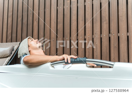 キャンプ場のサウナで水風呂に入る男性(外気浴,森林浴) キャンプ場のサウナで水風呂に入る男性(外気浴,森林浴) 127588964