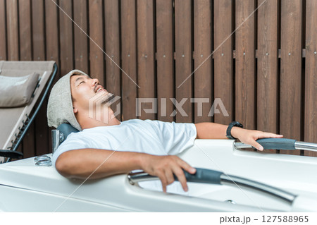 キャンプ場のサウナで水風呂に入る男性（外気浴,森林浴） 127588965