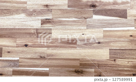 op view of light to medium tone wood laminate flooring with visible wood grain and knots, perfect for backgrounds, interior design mockups, or architectural renderings. 127589991