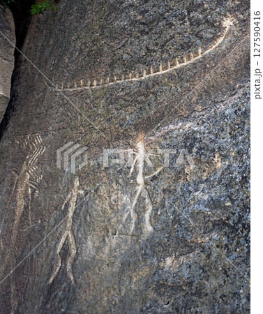 Ancient rock paintings petroglyphs of people with a boat in Gobustan National Park. Baku, Azerbaijan. 127590416