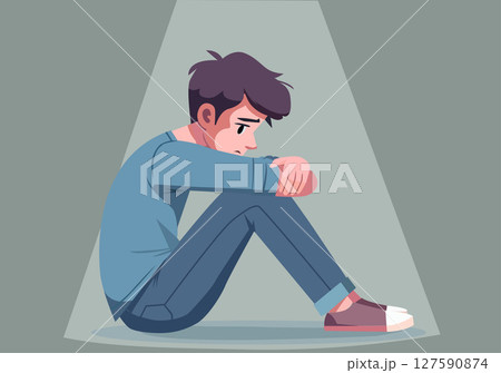 A young man sits hugging his knees in a sad or anxious mood. A young man sits hugging his knees in a sad or anxious mood. 127590874