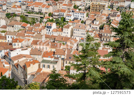 Showcase the beauty of a European town with tile roofs and greenery from above 127591573