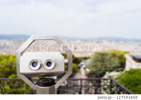 Cityscape can be observed through binoculars on a sunny day with clear skies 127591608