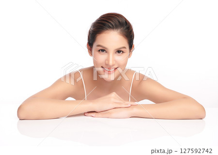 A beautiful young Asian woman with clean, fresh skin against a white background. Skincare, facial treatment, cosmetology, beauty, and spa. An elegant portrait of an Asian woman. A beautiful young Asian woman with clean, fresh skin against a white background. Skincare, facial treatment, cosmetology, beauty, and spa. An elegant portrait of an Asian woman. 127592742