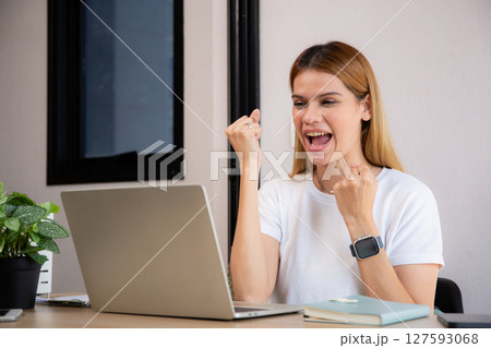 Young caucasian business woman using laptop computer for success in modern home office. Young caucasian business woman using laptop computer for success in modern home office. 127593068