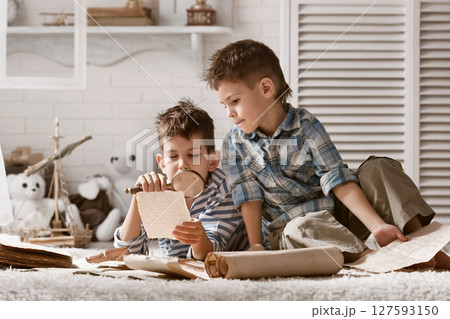 Two boys studying old maps Travel Two boys studying old maps Travel 127593150