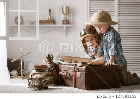 Boys in images traveler and pilot play in his room Boys in images traveler and pilot play in his room 127593159