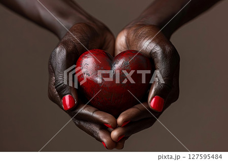 Embrace love with this striking image of hands cradling a stone heart, symbolizing warmth and connection Embrace love with this striking image of hands cradling a stone heart, symbolizing warmth and connection 127595484