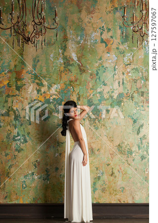 Perfect fashion woman in white silk dress posing in perfect interior 127597067