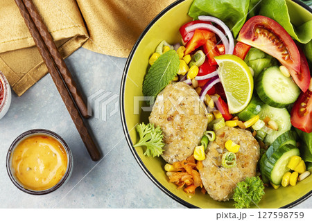 Lunch bowl of fish cutlets. Lunch bowl of fish cutlets. 127598759