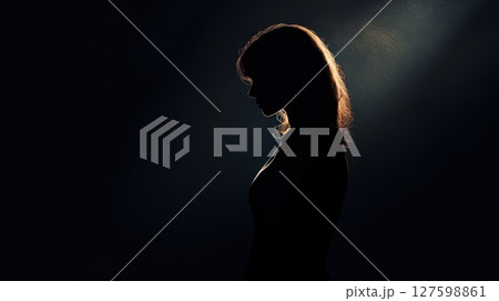 Woman Silhouette From The Darkness 127598861