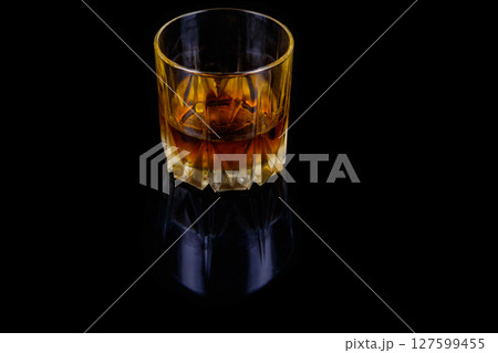Glass of whiskey on a black background Glass of whiskey on a black background 127599455