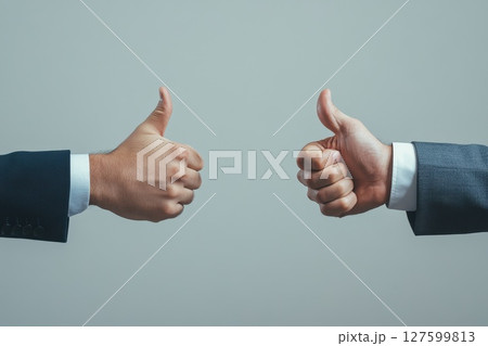 Two Businesspeople Giving Thumbs Up in Agreement and Positive Expression of Success Two Businesspeople Giving Thumbs Up in Agreement and Positive Expression of Success 127599813