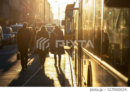 A group of people walking down a street with a bus in the background, daily transportation 127600024