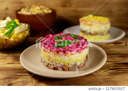 Set of festive mayonnaise salads on wooden table Set of festive mayonnaise salads on wooden table 127601027