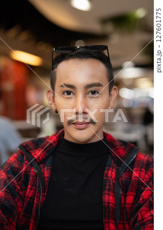 Portrait of nonbinary genderfluid young Asian gay man looking at camera 127601775