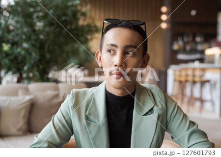 Portrait of nonbinary genderfluid young Asian gay man in coffee shop 127601793