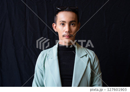 Portrait of nonbinary genderfluid young Asian gay man in studio 127601903