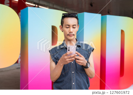 Portrait of confident non binary gay man during pride outdoors 127601972