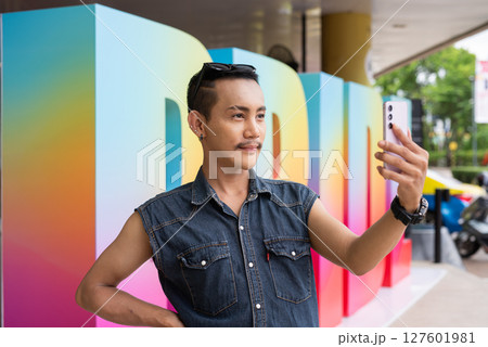 Portrait of confident non binary gay man during pride outdoors 127601981