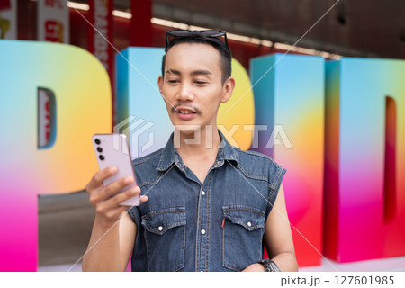 Portrait of confident non binary gay man during pride outdoors 127601985