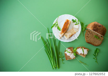 Sandwich with lard on rye bread and green onions on top 127602052